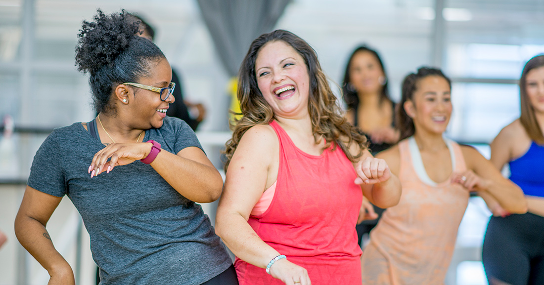 friends dancing in workout clothes